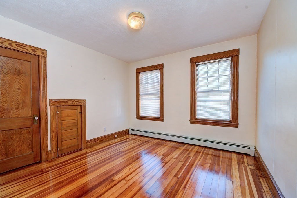 89-91 Larchwood Road Methuen, MA 01844 - Photo 28 of 39 an empty room with wooden floor and windows