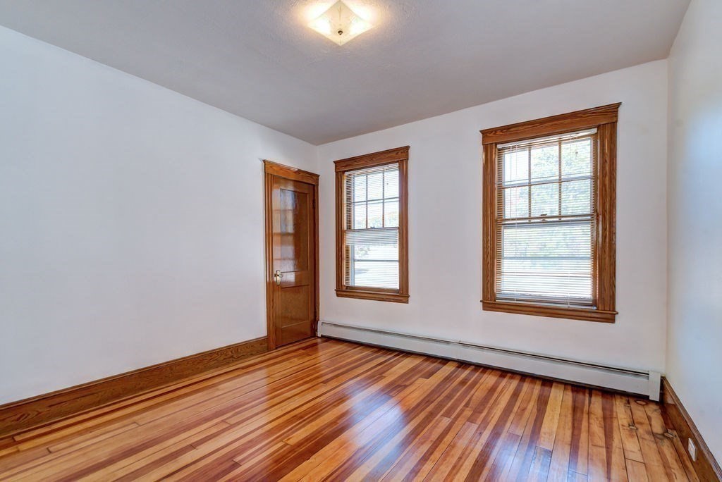 89-91 Larchwood Road Methuen, MA 01844 - Photo 29 of 39 an empty room with wooden floor and windows