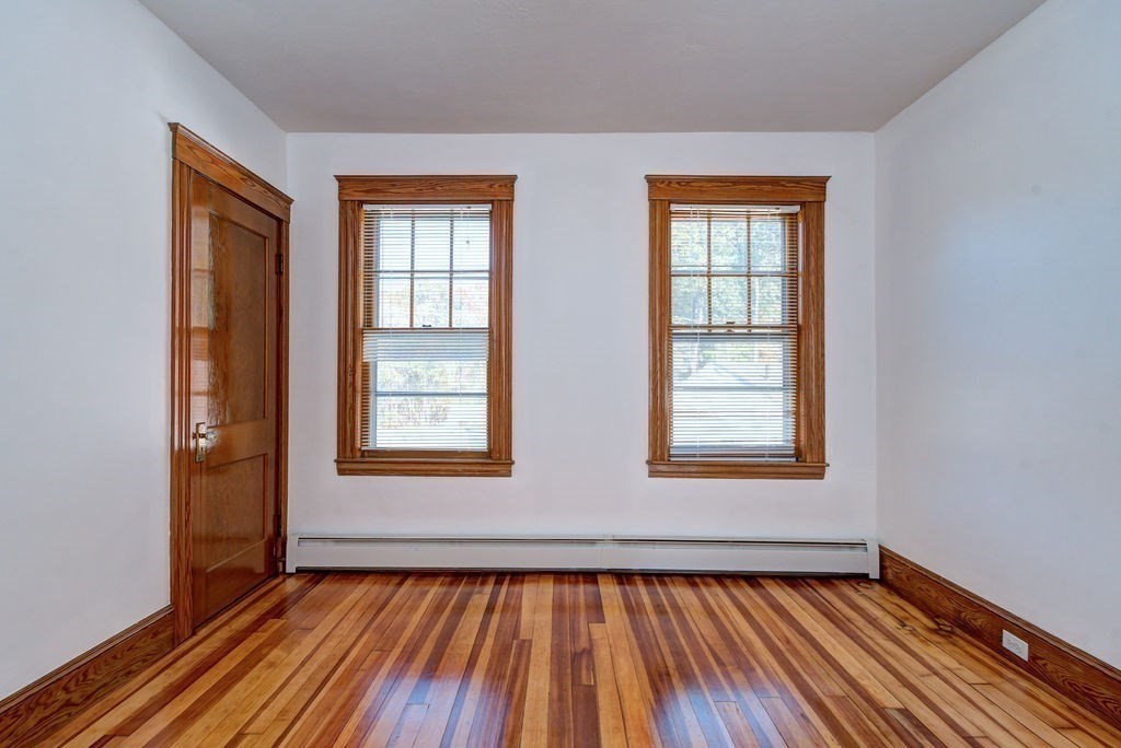89-91 Larchwood Road Methuen, MA 01844 - Photo 31 of 39 a view of an empty room with wooden floor and a window
