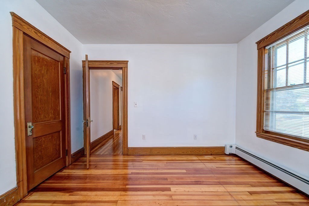 89-91 Larchwood Road Methuen, MA 01844 - Photo 35 of 39 a view of an empty room with wooden floor and a window
