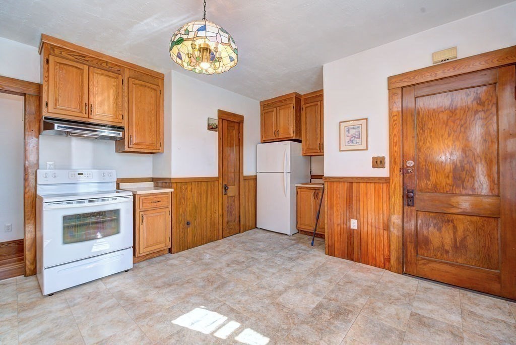 89-91 Larchwood Road Methuen, MA 01844 - Photo 37 of 39 a view of a kitchen with a stove cabinets and wooden floor