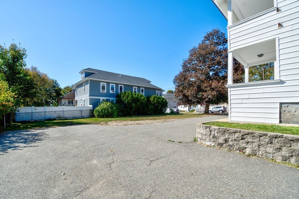 89-91 Larchwood Road Methuen, MA 01844 - Photo 6 of 39 a front view of a house with a yard and garage
