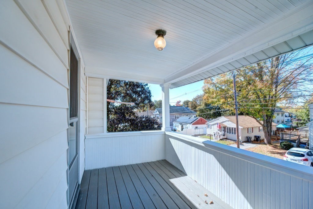 89-91 Larchwood Road Methuen, MA 01844 - Photo 7 of 39 a view of a living room with a window and wooden floor