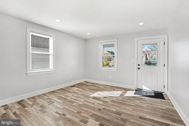 a view of a livingroom with wooden floor and window