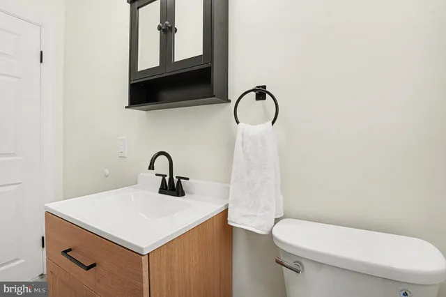a bathroom with a toilet sink and mirror