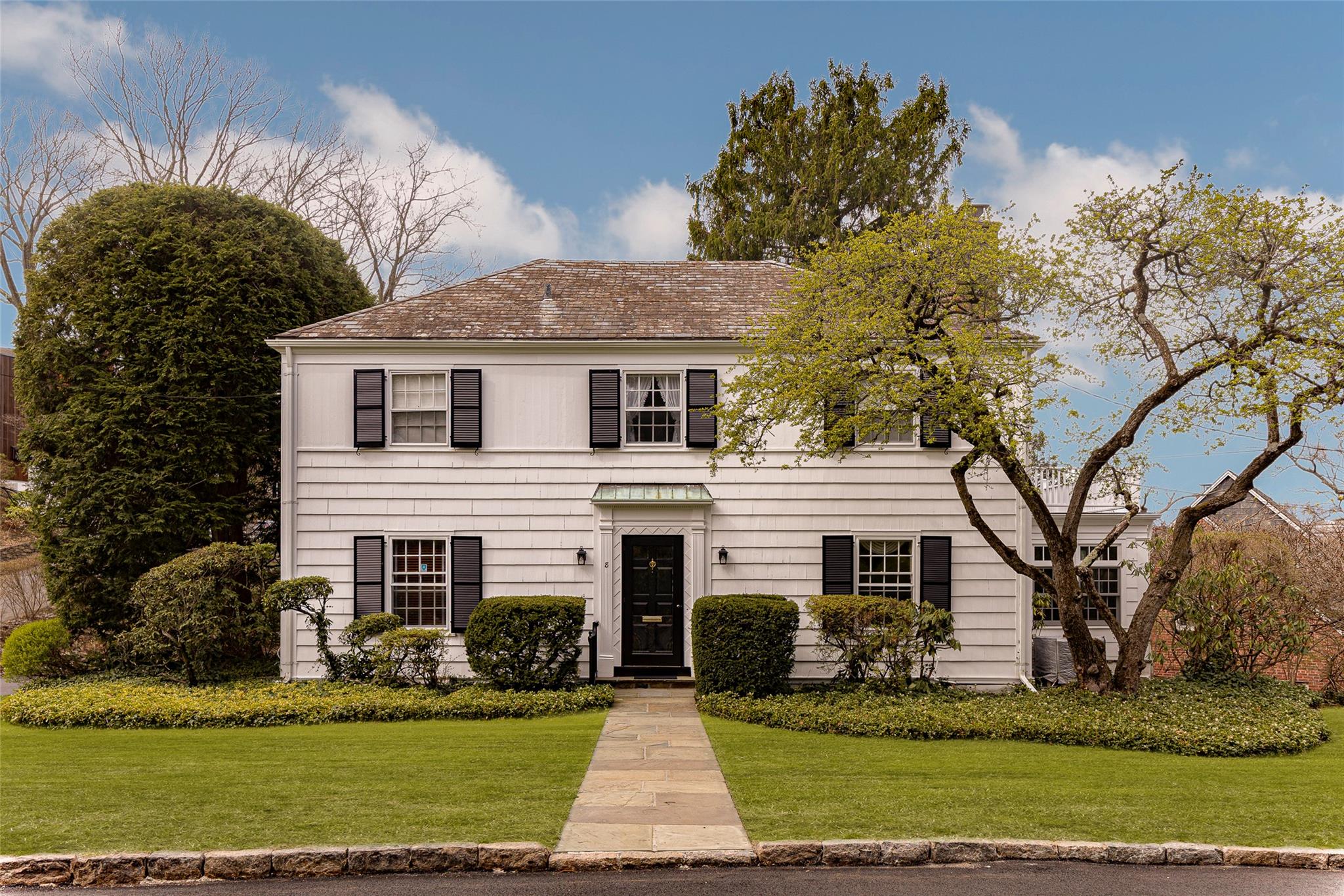 a front view of a house with a yard