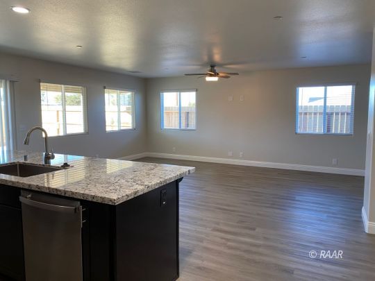 1629 Mayo Street Ridgecrest, CA 93555 - Photo 12 of 25 a kitchen with a sink cabinets and wooden floor