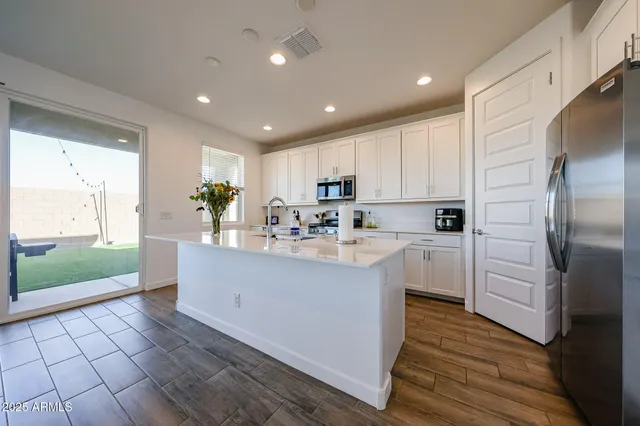 a kitchen with stainless steel appliances granite countertop a refrigerator sink and cabinets