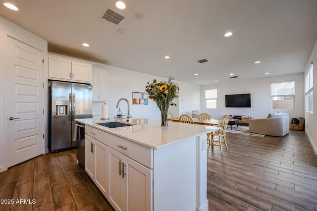 a kitchen with sink stove and refrigerator