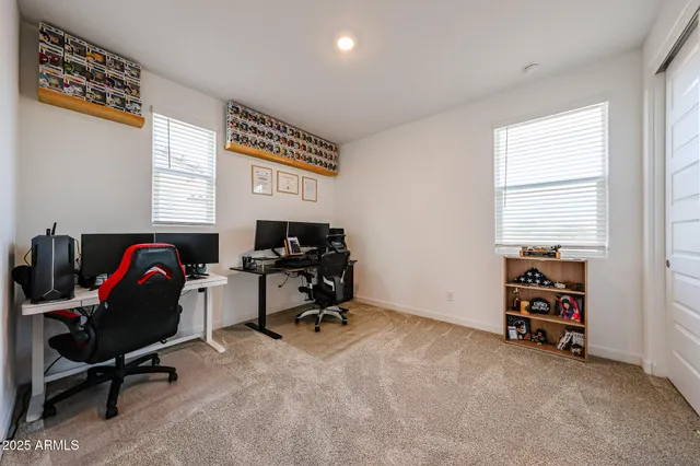 a view of a workspace with furniture and a window