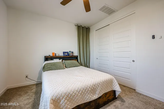 a bedroom with a bed and ceiling fan