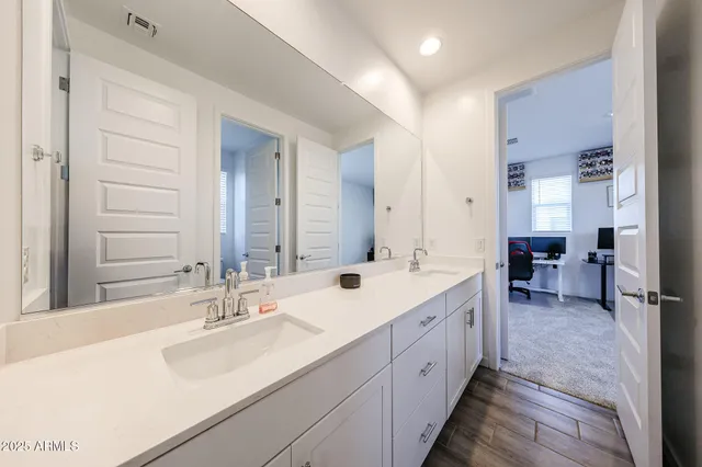 a spacious bathroom with a double vanity sink mirror and