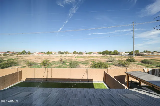 a view of a balcony with wooden floor and lake view