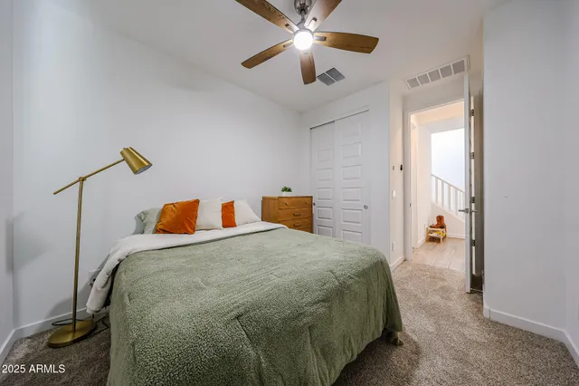 a bedroom with a bed and ceiling fan