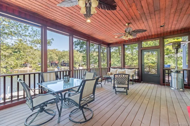 a dining room with furniture water view and wooden floor