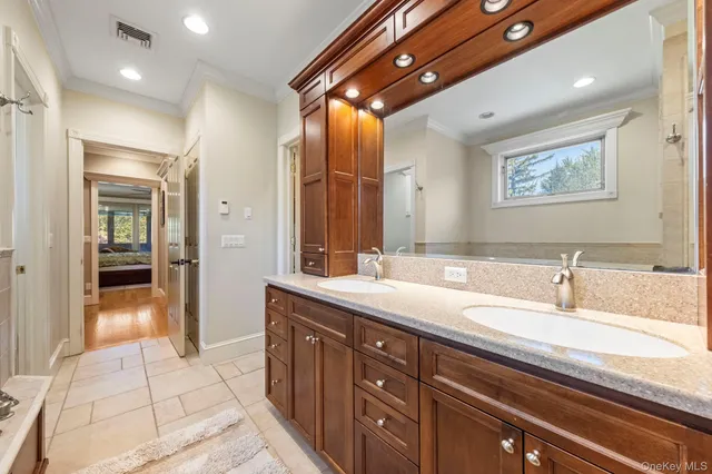 a spacious bathroom with a granite countertop sink a mirror and a