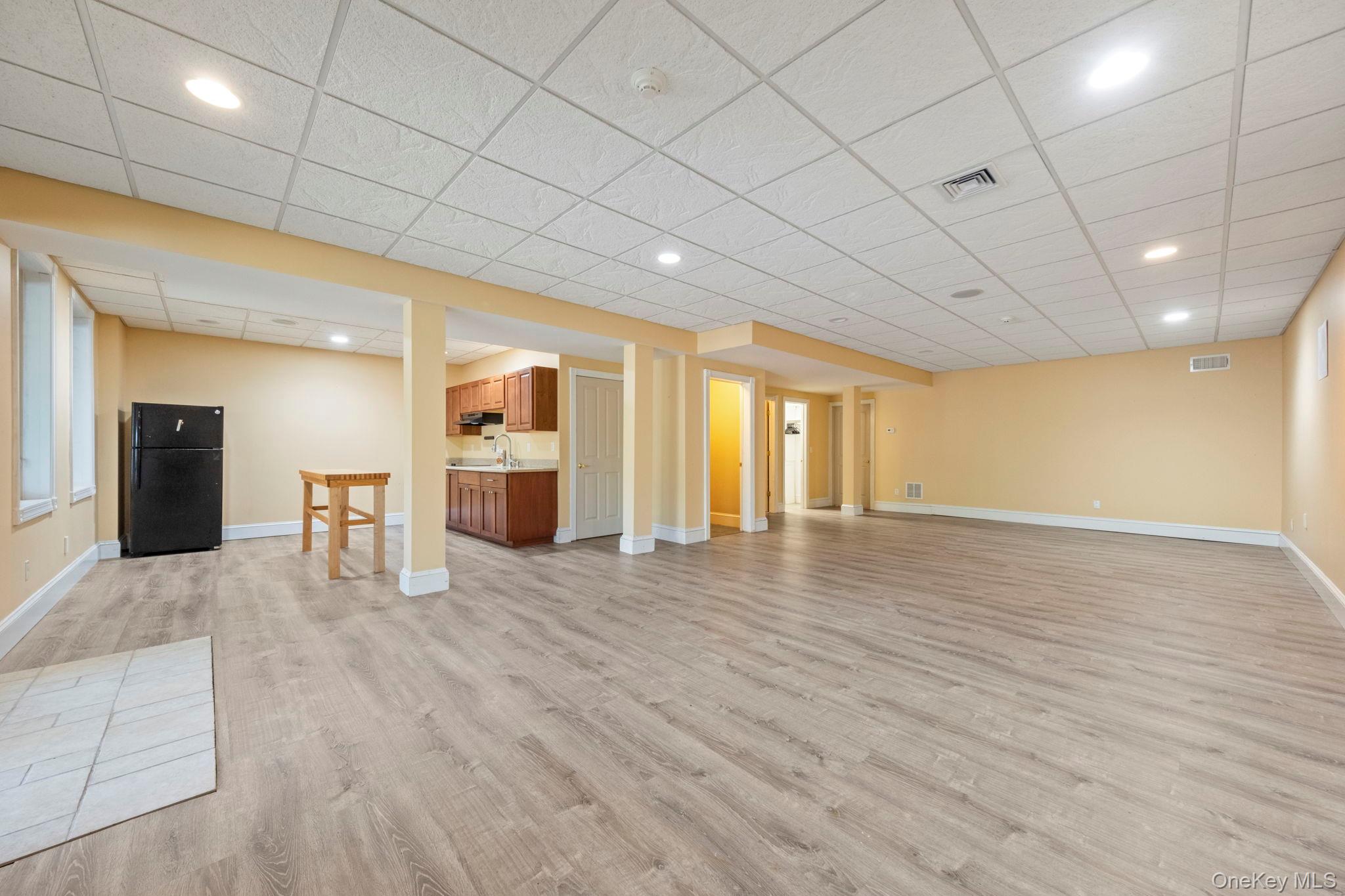62 Middletown Point Road Rock Hill, NY 12775 - Photo 28 of 42 a view of an empty room with wooden floor and a kitchen