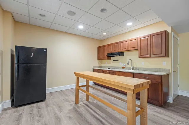 a kitchen with stainless steel appliances granite countertop a refrigerator and a stove top oven