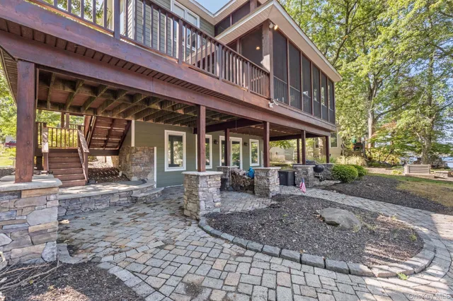 a view of a house with backyard porch and sitting area