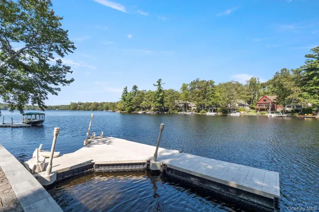 a view of a lake from balcony with outdoor seating