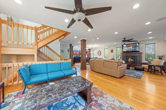 a living room with furniture ceiling fan and a rug