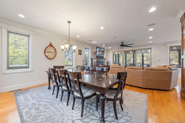 a dining room with furniture window and wooden floor