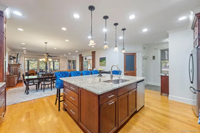 a large kitchen with kitchen island a large island a sink a stove and a refrigerator
