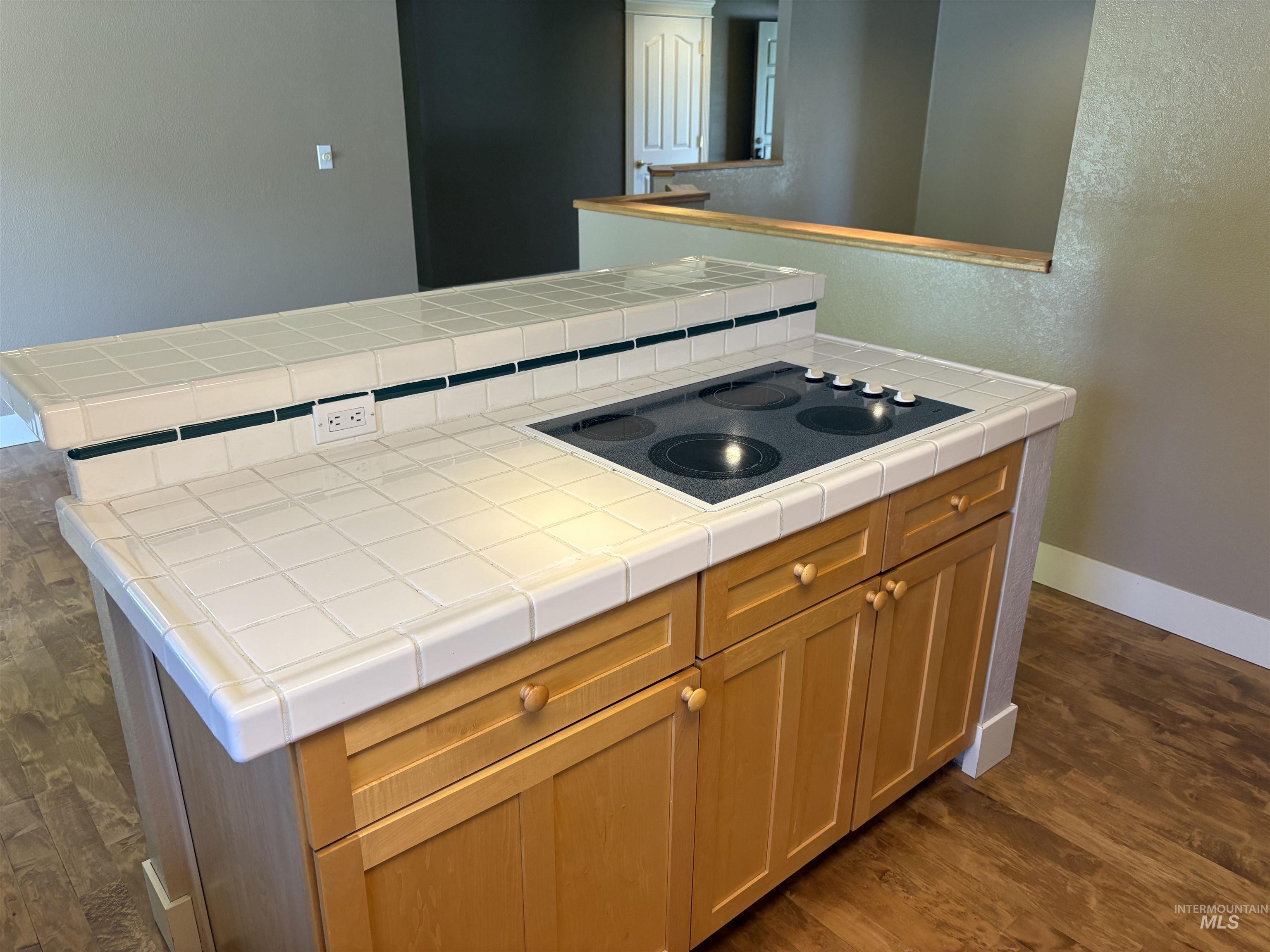 513 Ridge Way Ontario, OR 97914 - Photo 16 of 29 Kitchen featuring a tiled breakfast bar, wood-finish flooring, light wood cabinetry, a built-in wall oven, and a built-in microwave
