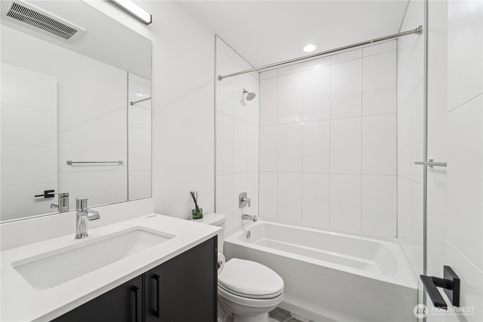 909 Hiawatha Place South, Unit B Seattle, WA 98144 - Photo 13 of 22 a bathroom with a sink a toilet and a large mirror