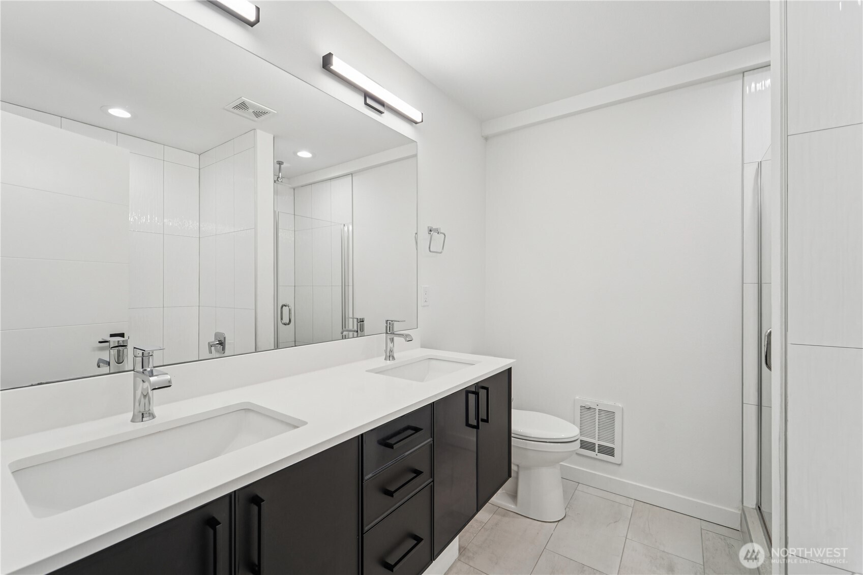909 Hiawatha Place South, Unit B Seattle, WA 98144 - Photo 17 of 22 a bathroom with a double vanity sink toilet and a mirror