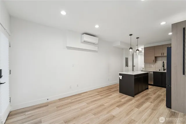 a view of kitchen with granite countertop cabinets and refrigerator