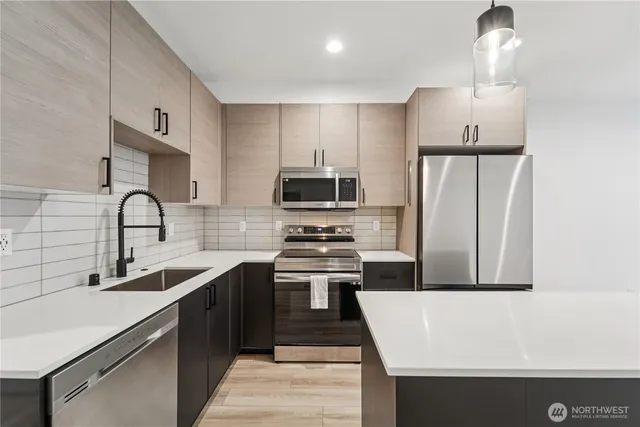 a kitchen with a sink a stove and refrigerator