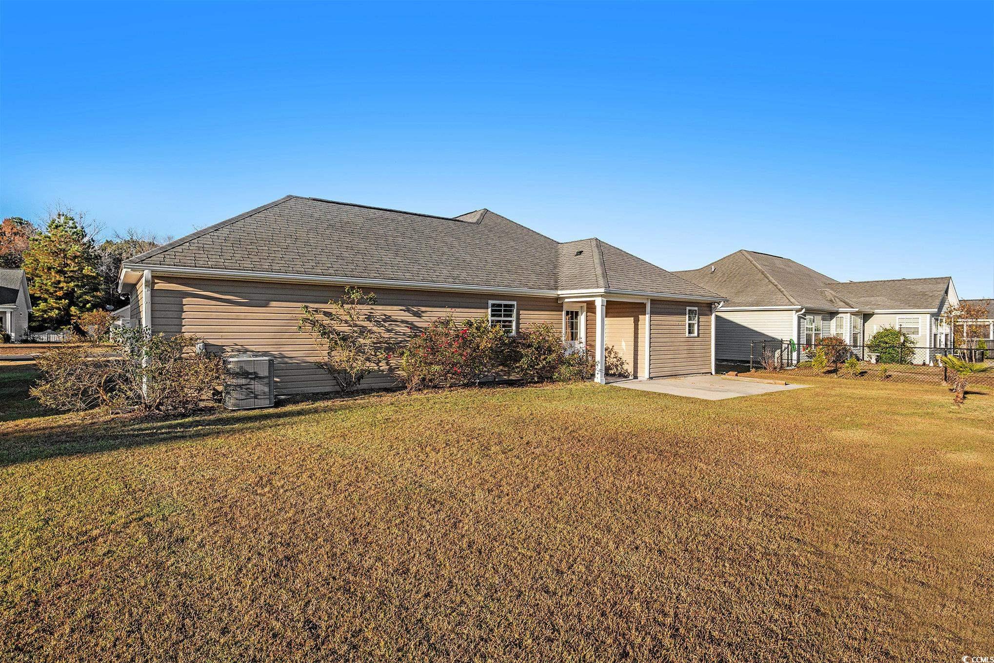 265 Georgia Mae Loop Conway, SC 29527 - Photo 19 of 28 Back of house featuring a patio area, a yard, and a shingled roof