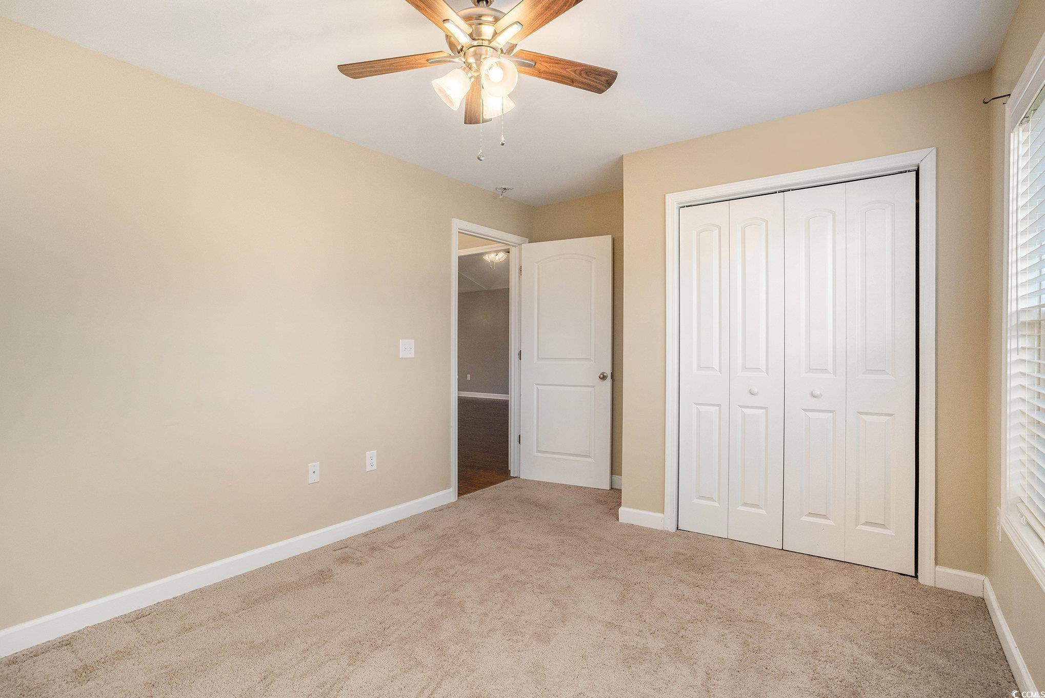265 Georgia Mae Loop Conway, SC 29527 - Photo 21 of 28 Unfurnished bedroom featuring light colored carpet, a closet, and a ceiling fan