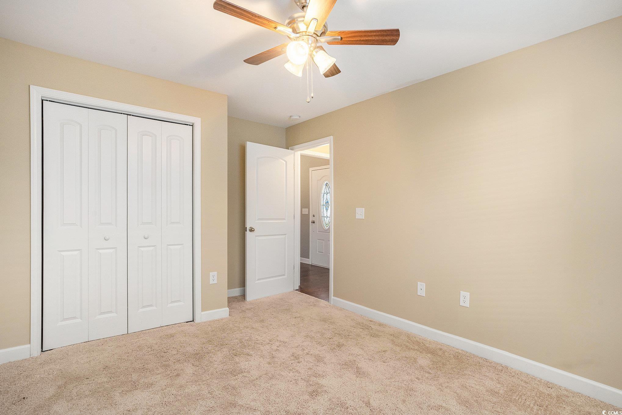 265 Georgia Mae Loop Conway, SC 29527 - Photo 24 of 28 Unfurnished bedroom with carpet floors, a closet, and a ceiling fan