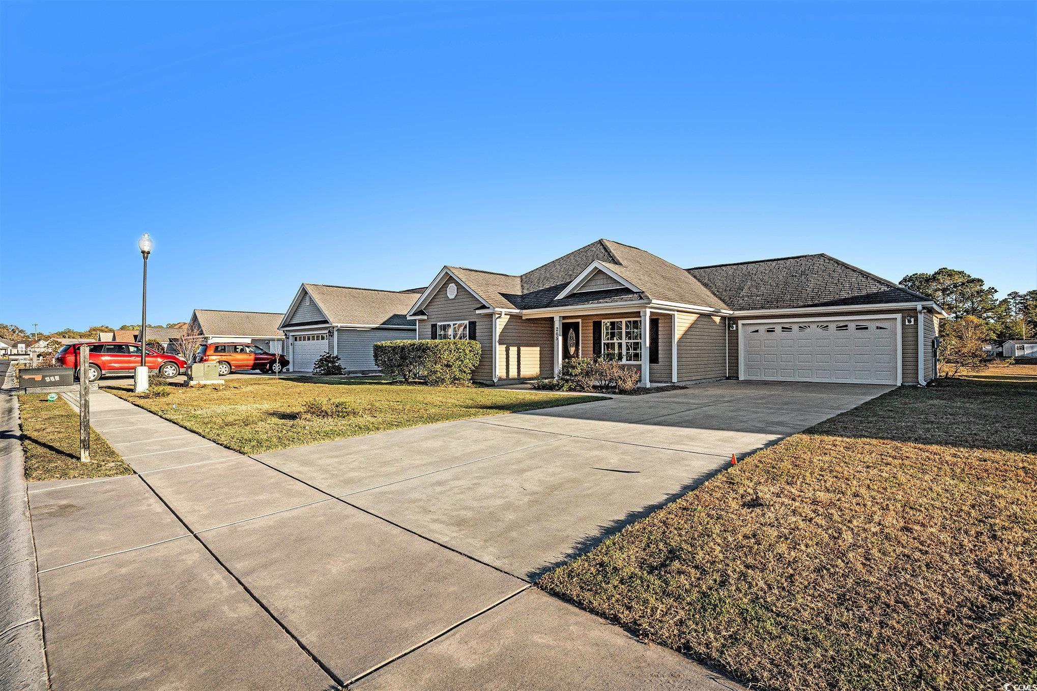265 Georgia Mae Loop Conway, SC 29527 - Photo 25 of 28 View of front of house featuring a front lawn, driveway, a shingled roof, covered porch, and a garage