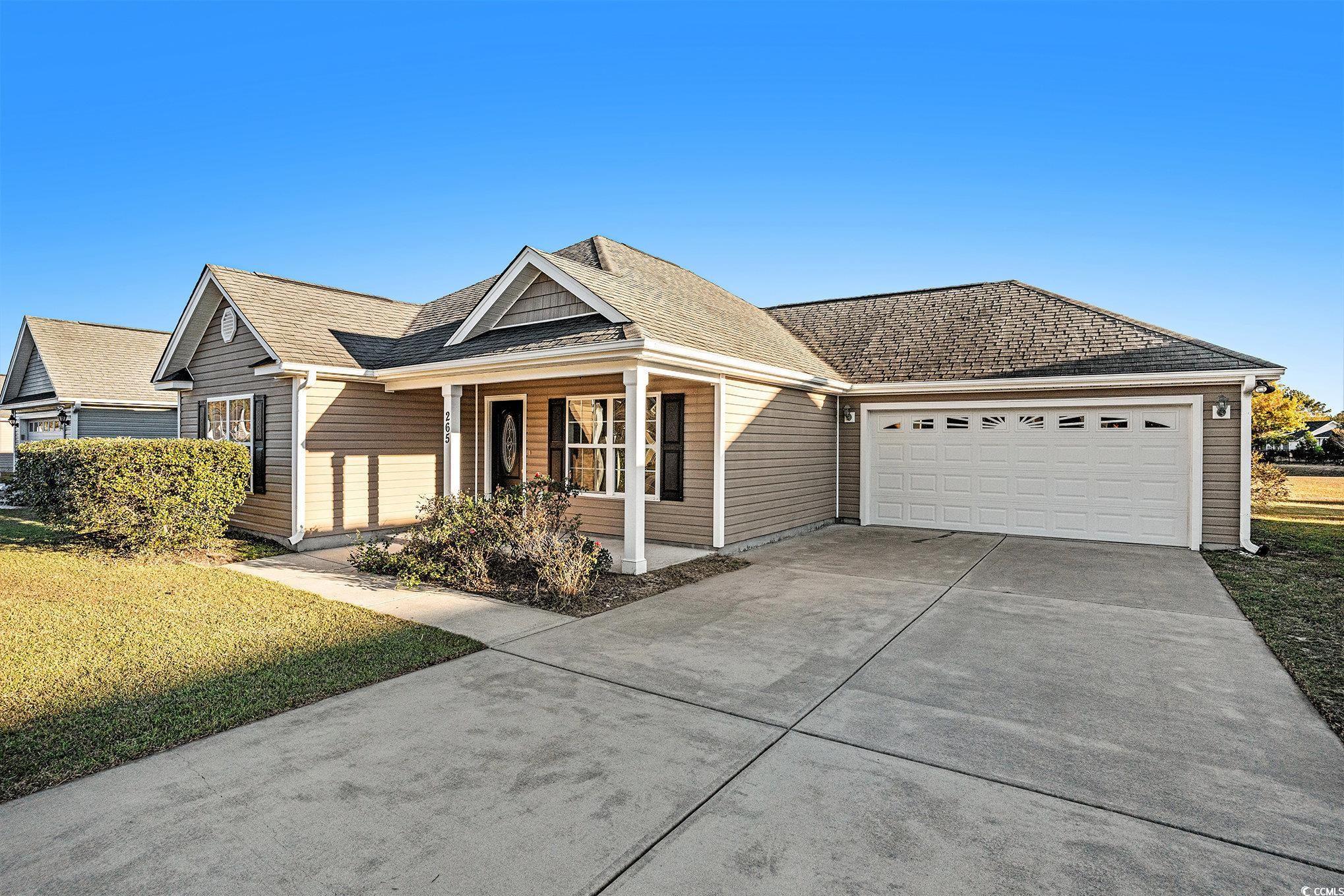 265 Georgia Mae Loop Conway, SC 29527 - Photo 26 of 28 Ranch-style house with a porch, driveway, roof with shingles, a front lawn, and an attached garage