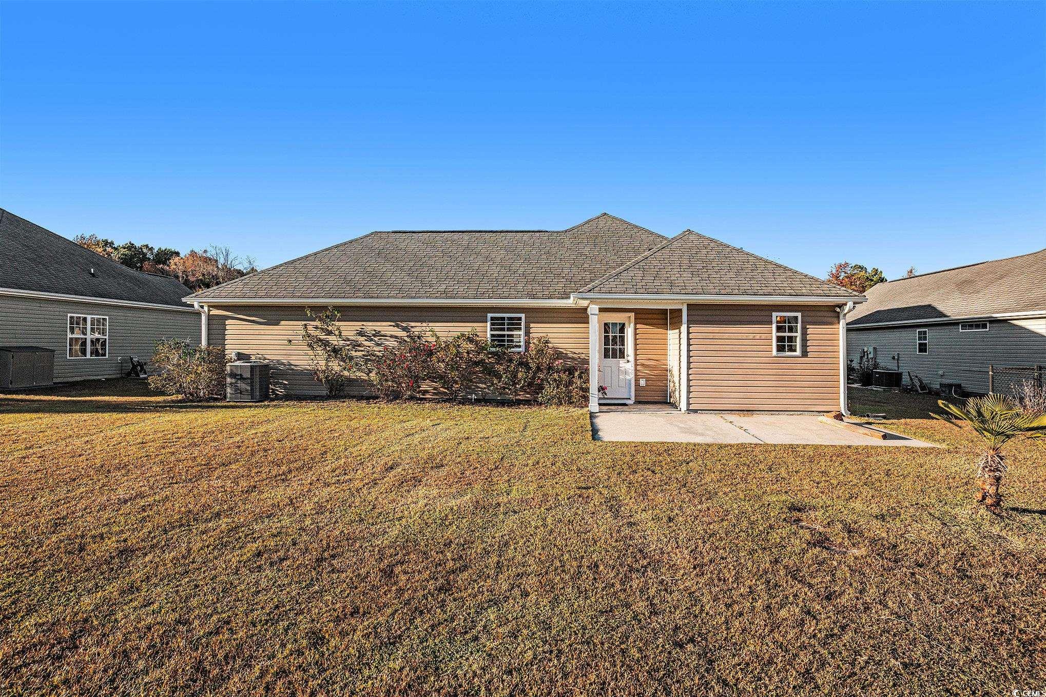 265 Georgia Mae Loop Conway, SC 29527 - Photo 27 of 28 Back of property featuring a lawn, a patio area, and a shingled roof