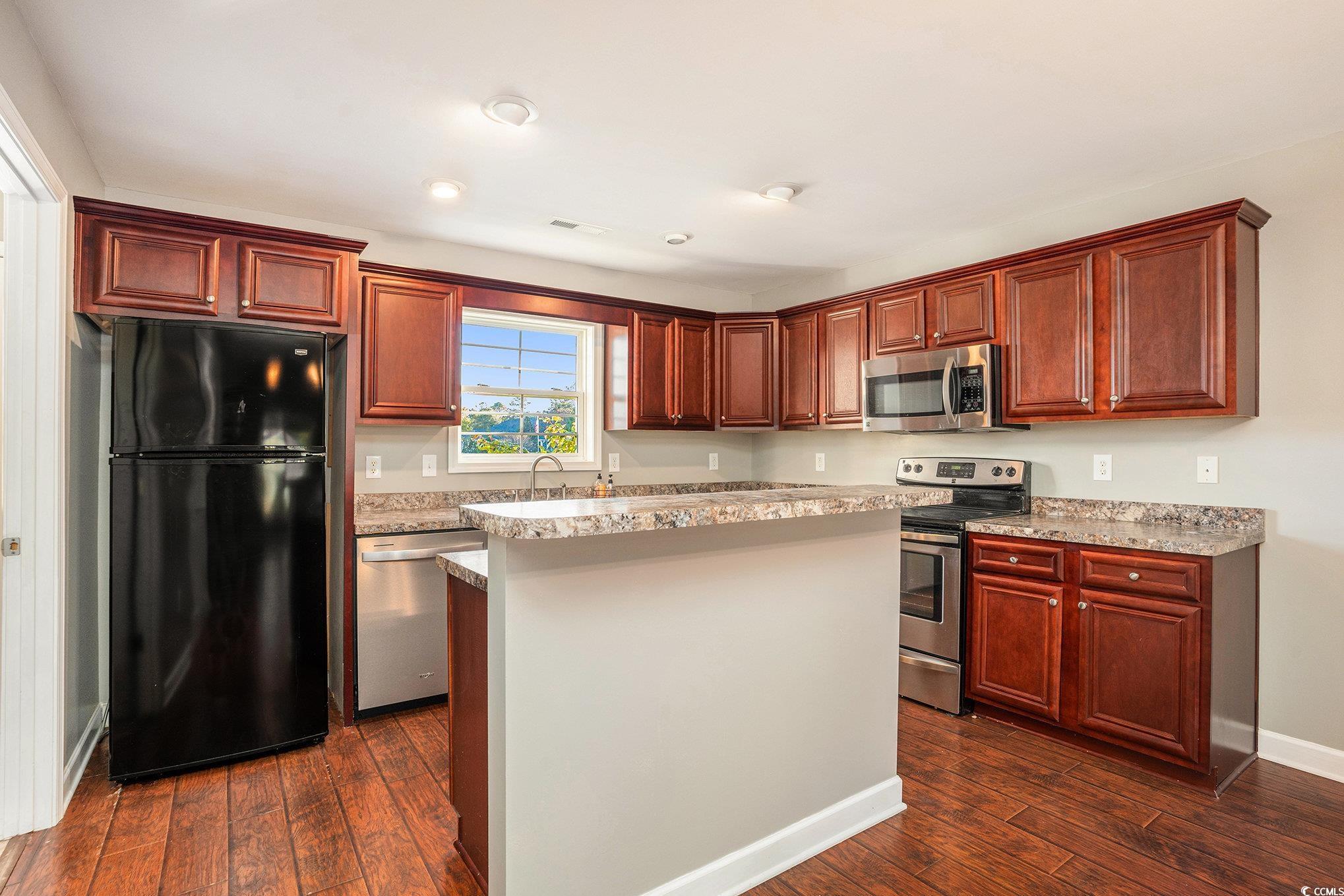 265 Georgia Mae Loop Conway, SC 29527 - Photo 5 of 28 Kitchen with stainless steel appliances, light countertops, a kitchen island, dark wood-style floors, and recessed lighting