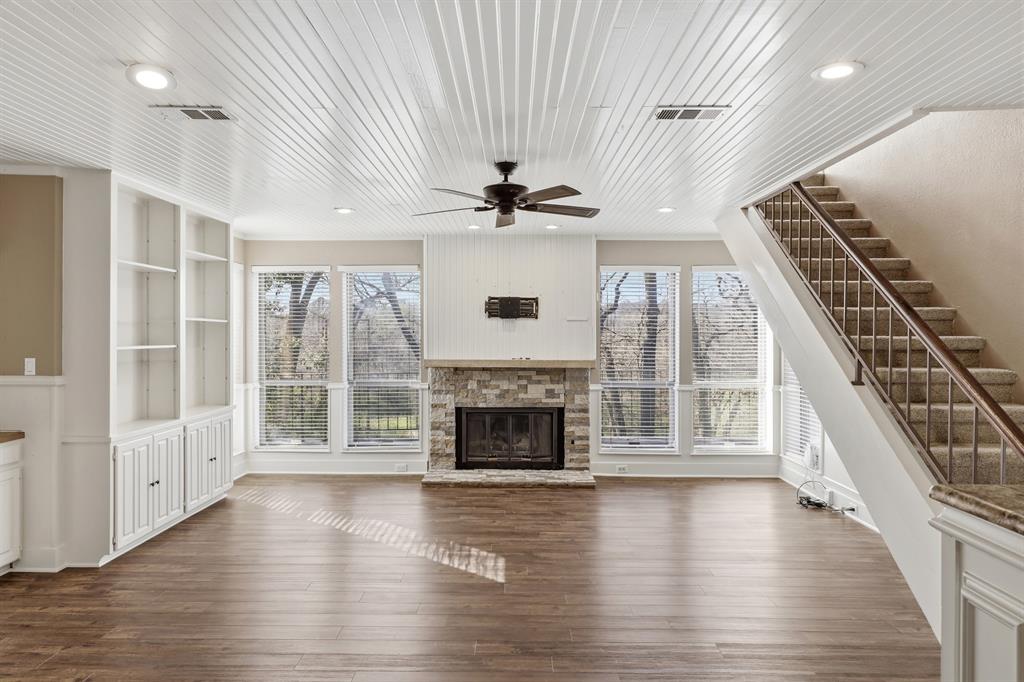 809 Cardinal Circle Bedford, TX 76022 - Photo 2 of 40 Gorgeous treehouse views from this open living room with the fireplace as the focal point. Beautiful ceiling detail with ship lap ceiling.