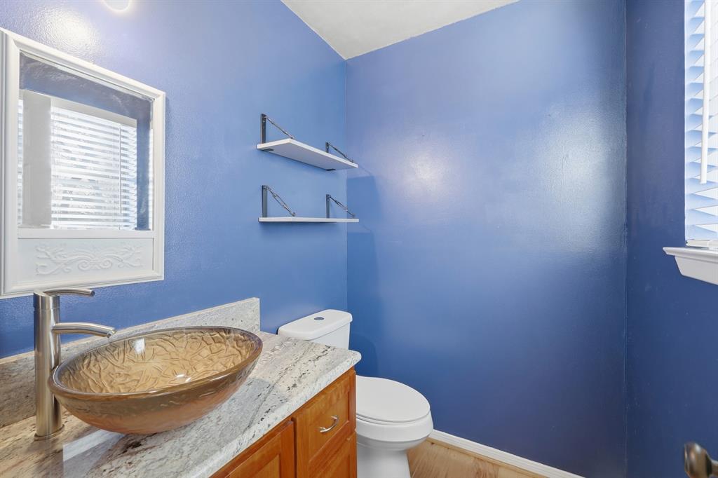 809 Cardinal Circle Bedford, TX 76022 - Photo 25 of 40 Half bath with updated bowl sink and granite counter.