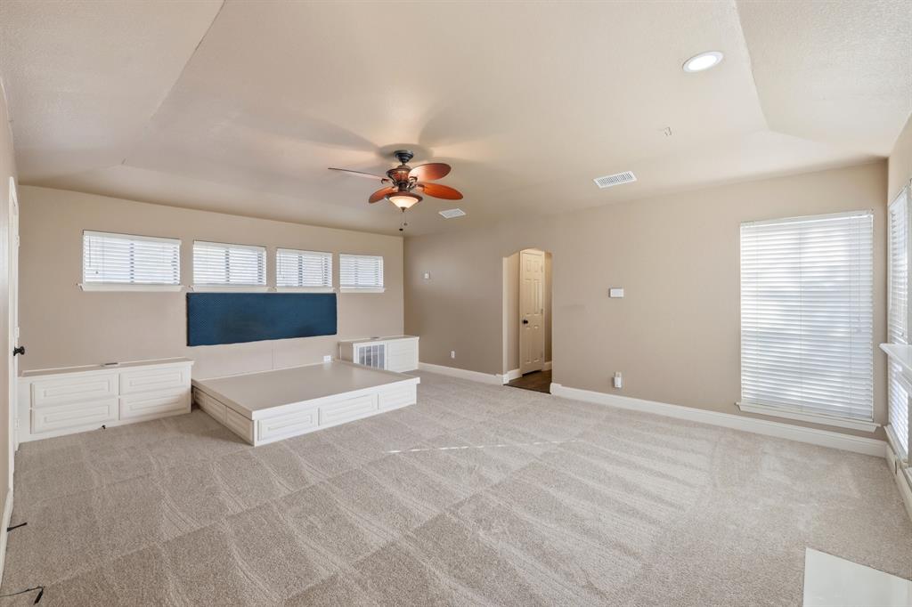 809 Cardinal Circle Bedford, TX 76022 - Photo 26 of 40 Huge upstairs primary bedroom with new carpet, built-in bed frame, and built in side tables with storage. Just bring your king-sized mattress!