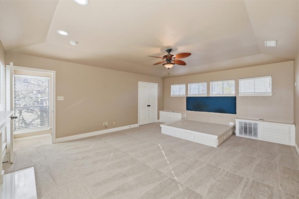 809 Cardinal Circle Bedford, TX 76022 - Photo 27 of 40 Huge primary bedroom is located upstairs with treehouse views and privacy. Just bring your king-sized mattress for this built-in bed and side tables.