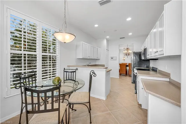 a kitchen with granite countertop a sink a stove top oven and cabinets