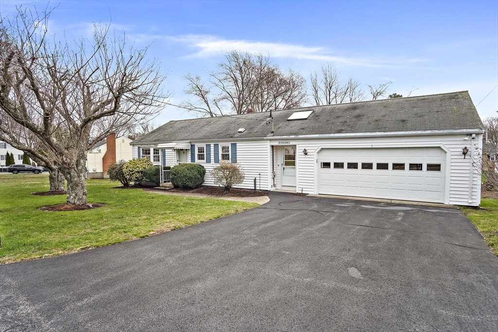 22 Anna Road Woburn, MA 01801 - Photo 1 of 37 a front view of a house with a yard and garage