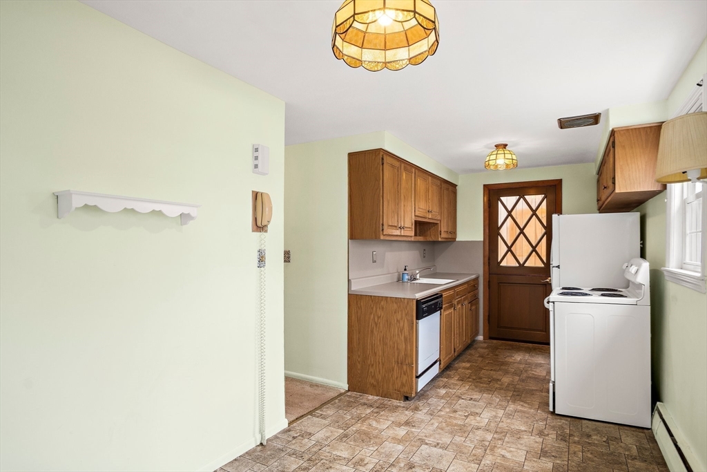 22 Anna Road Woburn, MA 01801 - Photo 11 of 37 a kitchen with stainless steel appliances granite countertop a refrigerator a stove and a sink