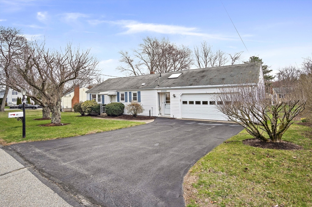 22 Anna Road Woburn, MA 01801 - Photo 3 of 37 a view of a house with a yard and potted plants