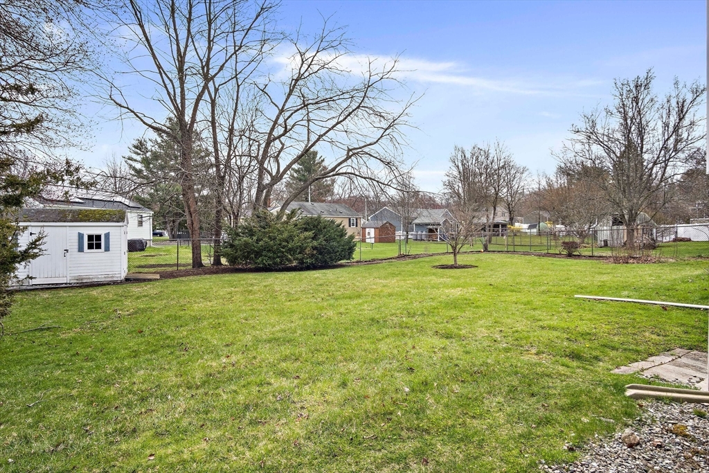 22 Anna Road Woburn, MA 01801 - Photo 32 of 37 a view of a house with a big yard and large trees