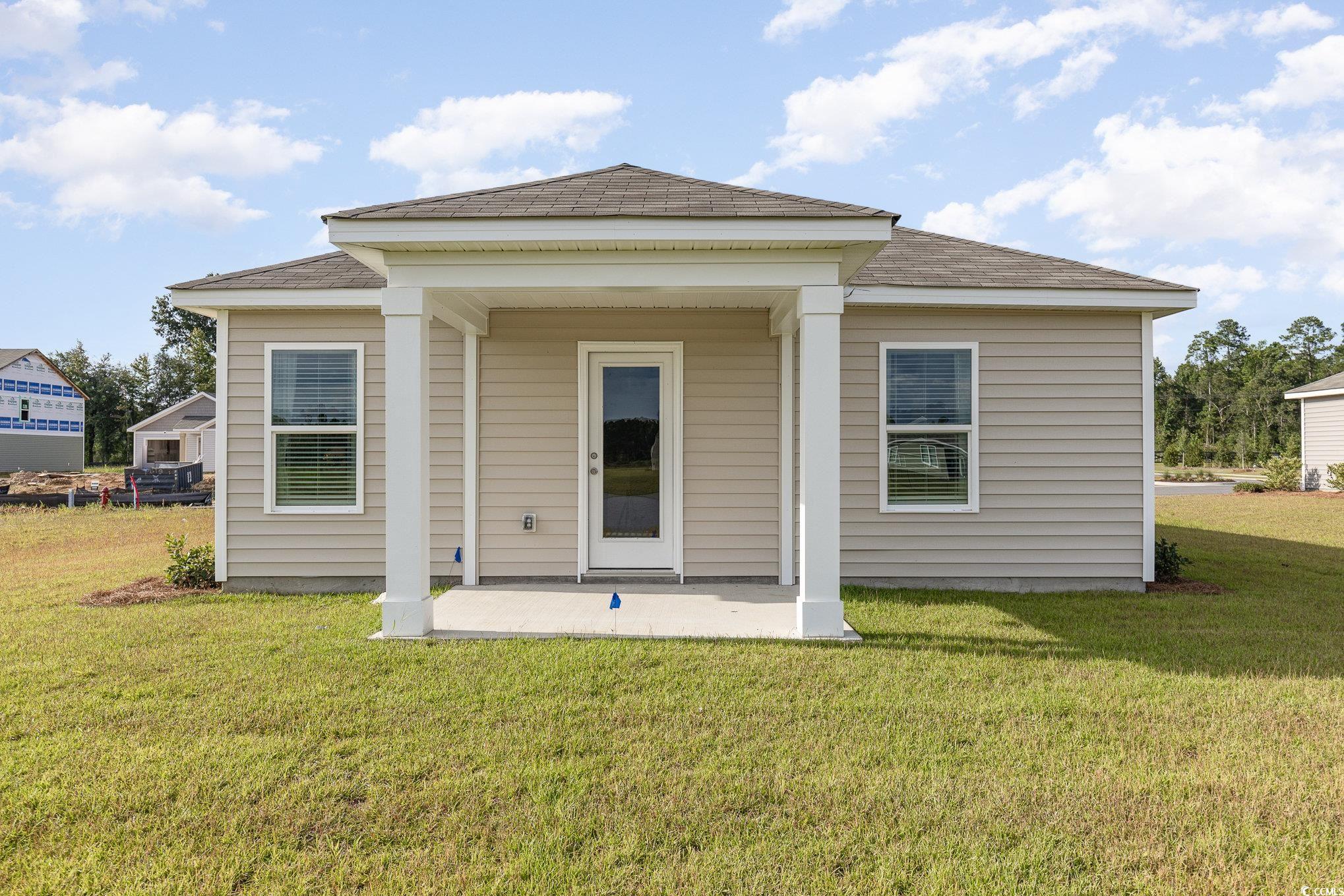 866 Farmers Passage Loop Loris, SC 29569 - Photo 20 of 25 Rear view of property with a patio area, a yard, and a shingled roof