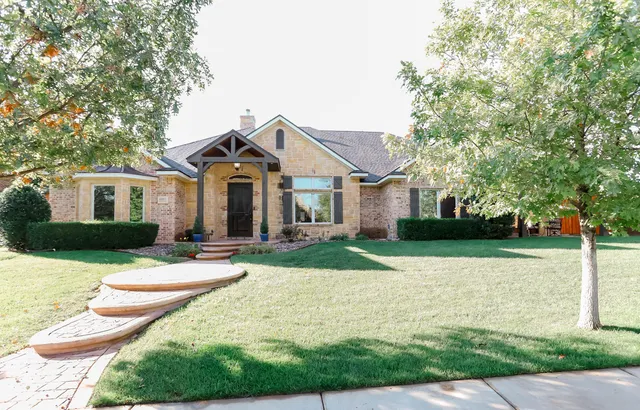a view of a livingroom with wooden floor and an entryway